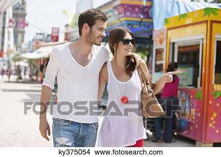 Couple walking in amusement park, Jardin des Tuileries, Paris, Ile-de-France, France View Large Photo Image Picture - Couple walking in amusement park, Jardin des Tuileries, Paris, Ile-de-France, France. Fotosearch