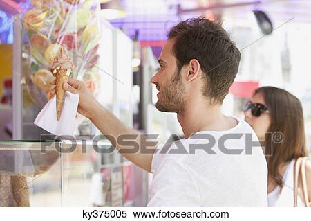 Man taking ice cream from an ice cream parlor, Paris, Ile-de-France, France View Large Photo Image Stock Photography - Man taking ice cream from an ice cream parlor, Paris, Ile-de-France, France. Fotosearch