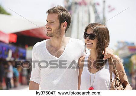 Man walking with his arm around a woman, Paris, Ile-de-France, France View Large Photo Image Stock Photo - Man walking with his arm around a woman, Paris, Ile-de-France, France. Fotosearch