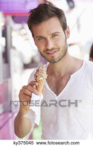 Portrait of a man eating ice cream, Paris, Ile-de-France, France View Large Photo Image Stock Photography - Portrait of a man eating ice cream, Paris, Ile-de-France, France. Fotosearch