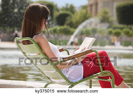 Woman reading a magazine, Jardin des Tuileries, Paris, Ile-de-France, France View Large Photo Image Stock Photography - Woman reading a magazine, Jardin des Tuileries, Paris, Ile-de-France, France. Fotosearch