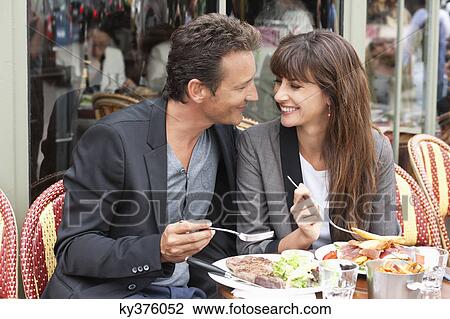 Stock Image - Couple enjoying lunch at a restaurant, Paris, Ile-de-France, France. Fotosearch
