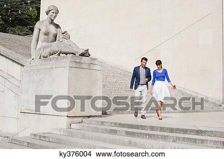 Picture - Couple moving down steps, Paris, Ile-de-France, France. Fotosearch