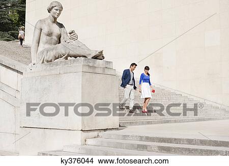 Picture - Couple moving down steps, Paris, Ile-de-France, France. Fotosearch