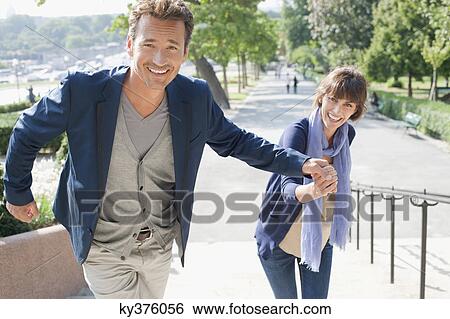 Couple moving up steps, Paris, Ile-de-France, France View Large Photo Image Stock Photograph - Couple moving up steps, Paris, Ile-de-France, France. Fotosearch