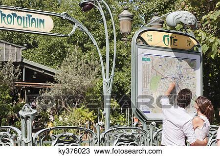 Couple pointing at a map, Paris, Ile-de-France, France View Large Photo Image Stock Image - Couple pointing at a map, Paris, Ile-de-France, France. Fotosearch