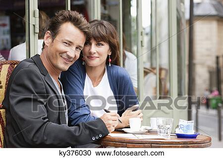 Couple sitting in a restaurant, Paris, Ile-de-France, France View Large Photo Image Stock Image - Couple sitting in a restaurant, Paris, Ile-de-France, France. Fotosearch