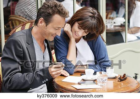 Couple sitting in a restaurant, Paris, Ile-de-France, France View Large Photo Image Stock Photo - Couple sitting in a restaurant, Paris, Ile-de-France, France. Fotosearch
