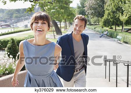 Couple walking on a walkway in a garden, Eiffel Tower, Paris, Ile-de-France, France View Large Photo Image Stock Photo - Couple walking on a walkway in a garden, Eiffel Tower, Paris, Ile-de-France, France. Fotosearch