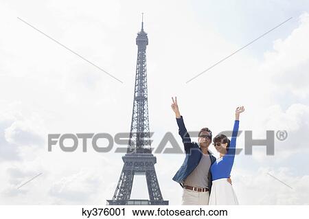 Couple waving hands with the Eiffel Tower in the background, Paris, Ile-de-France, France View Large Photo Image Stock Image - Couple waving hands with the Eiffel Tower in the background, Paris, Ile-de-France, France. Fotosearch