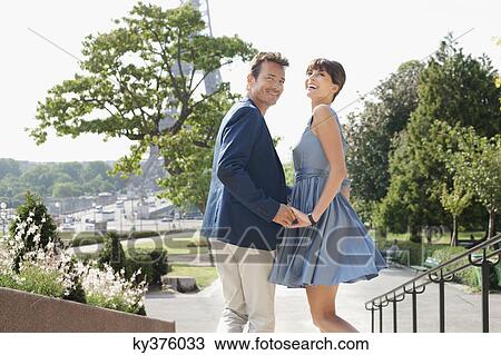 Couple with the Eiffel Tower in the background, Paris, Ile-de-France, France View Large Photo Image Stock Image - Couple with the Eiffel Tower in the background, Paris, Ile-de-France, France. Fotosearch