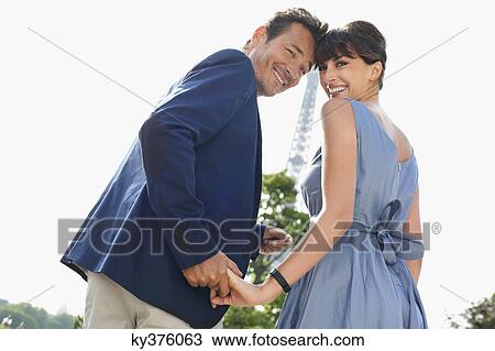 Couple with the Eiffel Tower in the background, Paris, Ile-de-France, France View Large Photo Image Stock Image - Couple with the Eiffel Tower in the background, Paris, Ile-de-France, France. Fotosearch