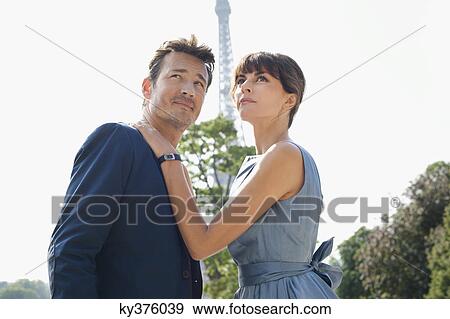 Stock Photo - Couple with the Eiffel Tower in the background, Paris, Ile-de-France, France. Fotosearch