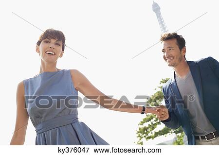Couple with the Eiffel Tower in the background, Paris, Ile-de-France, France View Large Photo Image Stock Photo - Couple with the Eiffel Tower in the background, Paris, Ile-de-France, France. Fotosearch