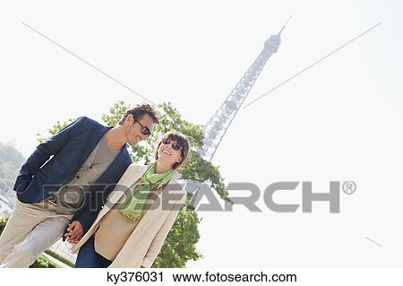 Happy couple with the Eiffel Tower in the background, Paris, Ile-de-France, France View Large Photo Image Stock Image - Happy couple with the Eiffel Tower in the background, Paris, Ile-de-France, France. Fotosearch
