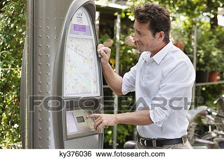 Man looking a map in a ticket machine, Paris, Ile-de-France, France View Large Photo Image Stock Photograph - Man looking a map in a ticket machine, Paris, Ile-de-France, France. Fotosearch