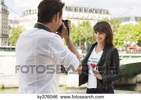 Man taking a picture of a woman with a camera, Seine River, Paris, Ile-de-France, France View Large Photo Image Stock Photograph - Man taking a picture of a woman with a camera, Seine River, Paris, Ile-de-France, France. Fotosearch