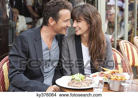 Romantic couple at a restaurant, Paris, Ile-de-France, France View Large Photo Image Picture - Romantic couple at a restaurant, Paris, Ile-de-France, France. Fotosearch