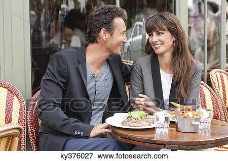 Stock Photo - Romantic couple at a restaurant, Paris, Ile-de-France, France. Fotosearch