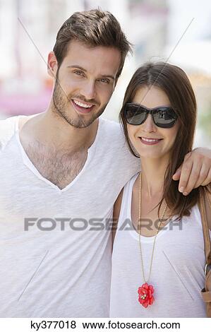 Stock Photo - Close-up of a couple smiling together, Paris, Ile-de-France, France. Fotosearch