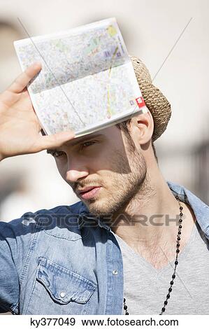 Close-up of a man holding a map, Paris, Ile-de-France, France View Large Photo Image Stock Photo - Close-up of a man holding a map, Paris, Ile-de-France, France. Fotosearch