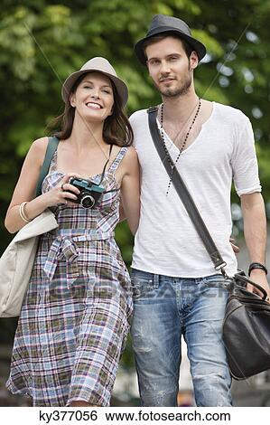 Couple walking on a road and smiling, Paris, Ile-de-France, France View Large Photo Image Stock Photograph - Couple walking on a road and smiling, Paris, Ile-de-France, France. Fotosearch