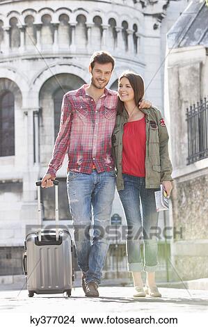 Couple walking on a road with a suitcase, Paris, Ile-de-France, France View Large Photo Image Picture - Couple walking on a road with a suitcase, Paris, Ile-de-France, France. Fotosearch