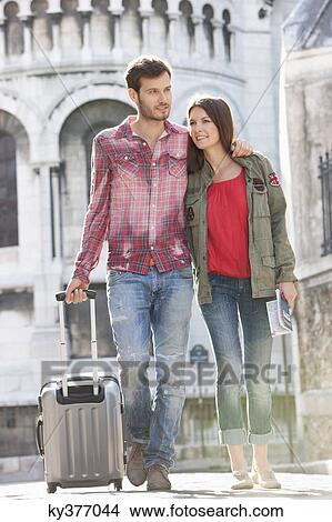 Couple walking on a road with a suitcase, Paris, Ile-de-France, France View Large Photo Image Picture - Couple walking on a road with a suitcase, Paris, Ile-de-France, France. Fotosearch
