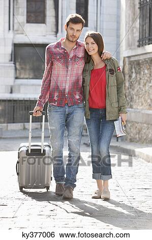Couple walking on a road with a suitcase, Paris, Ile-de-France, France View Large Photo Image Stock Photograph - Couple walking on a road with a suitcase, Paris, Ile-de-France, France. Fotosearch