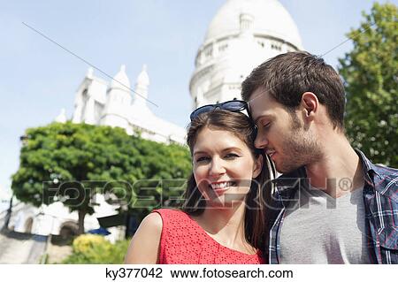 Stock Image - Man kissing a woman smiling, Montmartre, Paris, Ile-de-France, France. Fotosearch