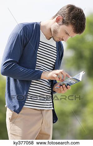 Man reading a travel guidebook, Paris, Ile-de-France, France View Large Photo Image Stock Photo - Man reading a travel guidebook, Paris, Ile-de-France, France. Fotosearch
