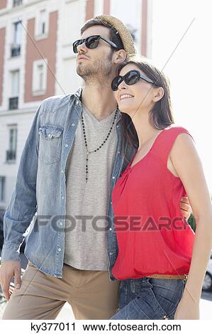 Man standing with his arm around a woman, Paris, Ile-de-France, France View Large Photo Image Stock Image - Man standing with his arm around a woman, Paris, Ile-de-France, France. Fotosearch