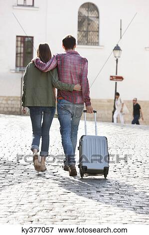 Rear view of a couple walking on a road with a suitcase, Paris, Ile-de-France, France View Large Photo Image Stock Photo - Rear view of a couple walking on a road with a suitcase, Paris, Ile-de-France, France. Fotosearch