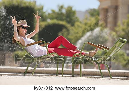 Woman sitting in a chair near a pond and gesturing, Bassin octogonal, Jardin des Tuileries, Paris, Ile-de-France, France View Large Photo Image Stock Image - Woman sitting in a chair near a pond and gesturing, Bassin octogonal, Jardin des Tuileries, Paris, Ile-de-France, France. Fotosearch