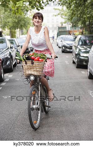 Woman carrying vegetables on a bicycle, Paris, Ile-de-France, France View Large Photo Image Stock Image - Woman carrying vegetables on a bicycle, Paris, Ile-de-France, France. Fotosearch