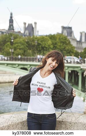 Stock Photo - Woman enjoying at the riverside, Seine River, Paris, Ile-de-France, France. Fotosearch