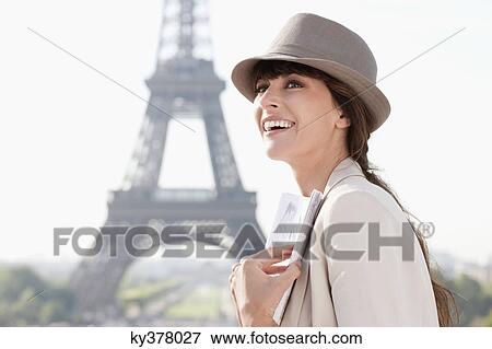 Woman holding a guide book with the Eiffel Tower in the background, Paris, Ile-de-France, France View Large Photo Image Stock Photo - Woman holding a guide book with the Eiffel Tower in the background, Paris, Ile-de-France, France. Fotosearch