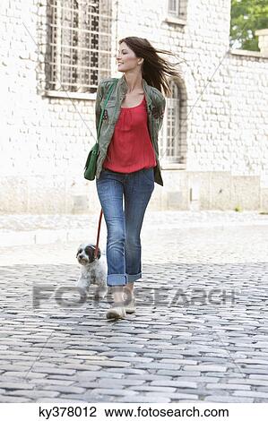 Woman holding a puppy on leash, Paris, Ile-de-France, France View Large Photo Image Stock Image - Woman holding a puppy on leash, Paris, Ile-de-France, France. Fotosearch