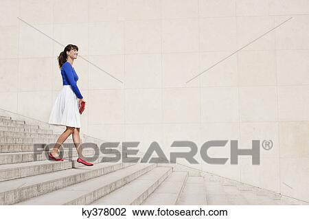 Woman moving down steps, Paris, Ile-de-France, France View Large Photo Image Stock Image - Woman moving down steps, Paris, Ile-de-France, France. Fotosearch
