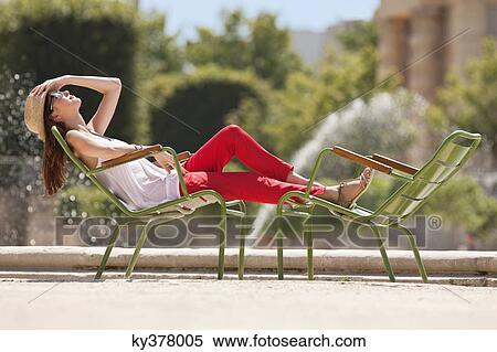 Woman resting in a chair near a pond, Bassin octogonal, Jardin des Tuileries, Paris, Ile-de-France, France View Large Photo Image Stock Photography - Woman resting in a chair near a pond, Bassin octogonal, Jardin des Tuileries, Paris, Ile-de-France, France. Fotosearch