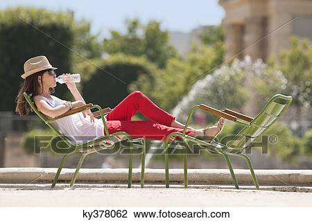Woman sitting in a chair and drinking water, Bassin octogonal, Jardin des Tuileries, Paris, Ile-de-France, France View Large Photo Image Stock Image - Woman sitting in a chair and drinking water, Bassin octogonal, Jardin des Tuileries, Paris, Ile-de-France, France. Fotosearch