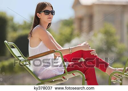 Woman sitting in a chair, Bassin octogonal, Jardin des Tuileries, Paris, Ile-de-France, France View Large Photo Image Stock Photo - Woman sitting in a chair, Bassin octogonal, Jardin des Tuileries, Paris, Ile-de-France, France. Fotosearch