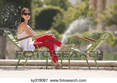 Woman sitting in a chair, Bassin octogonal, Jardin des Tuileries, Paris, Ile-de-France, France View Large Photo Image Stock Photo - Woman sitting in a chair, Bassin octogonal, Jardin des Tuileries, Paris, Ile-de-France, France. Fotosearch