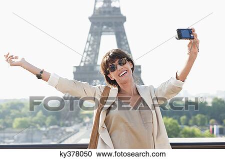 Woman taking a picture of herself with the Eiffel Tower in the background, Paris, Ile-de-France, France View Large Photo Image Stock Image - Woman taking a picture of herself with the Eiffel Tower in the background, Paris, Ile-de-France, France. Fotosearch