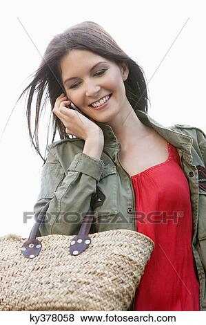 Woman talking on a mobile phone, Paris, Ile-de-France, France View Large Photo Image Stock Photo - Woman talking on a mobile phone, Paris, Ile-de-France, France. Fotosearch