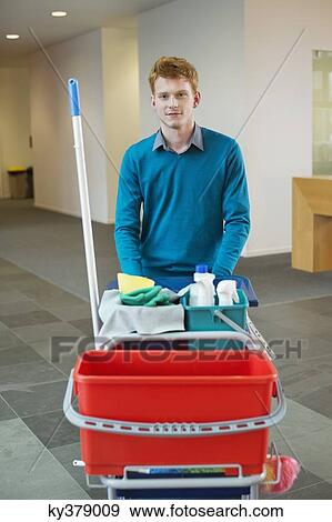 Male cleaner pushing trolley with cleaning equipment View Large Photo Image Stock Photo - Male cleaner pushing trolley with cleaning equipment. Fotosearch