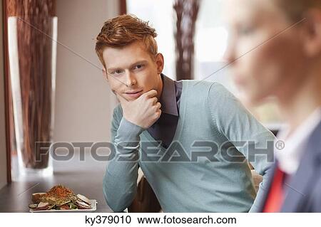 Man in a restaurant looking at a businesswoman View Large Photo Image Stock Image - Man in a restaurant looking at a businesswoman. Fotosearch