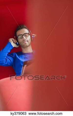 Man listening to headphones View Large Photo Image Stock Image - Man listening to headphones. Fotosearch