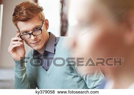 Stock Photo - Man looking at a businesswoman. Fotosearch