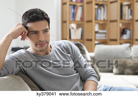 Man resting on a couch View Large Photo Image Stock Image - Man resting on a couch. Fotosearch